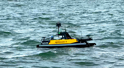 small yellow and black unmanned vessel on the surface of the water 