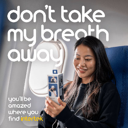A woman sitting in a passenger plane holding a fuu neck pillow package