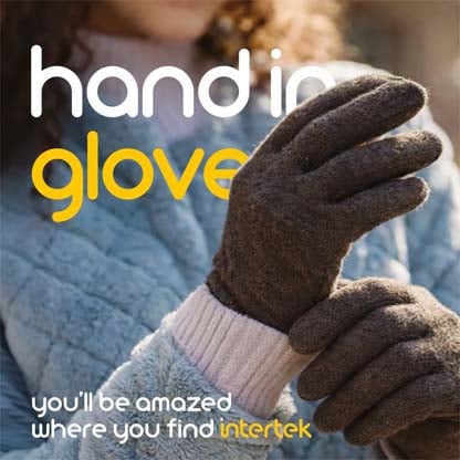 A pair of knit gloves worn by a woman outdoors